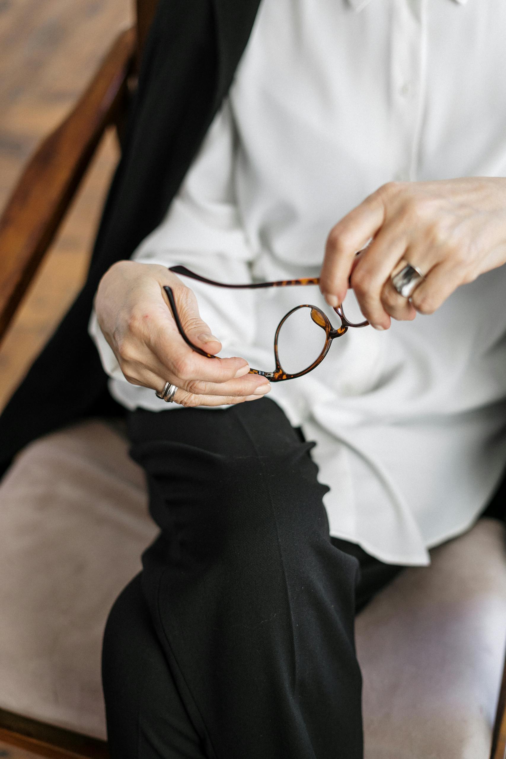Person Holding Silver and Gold Ring